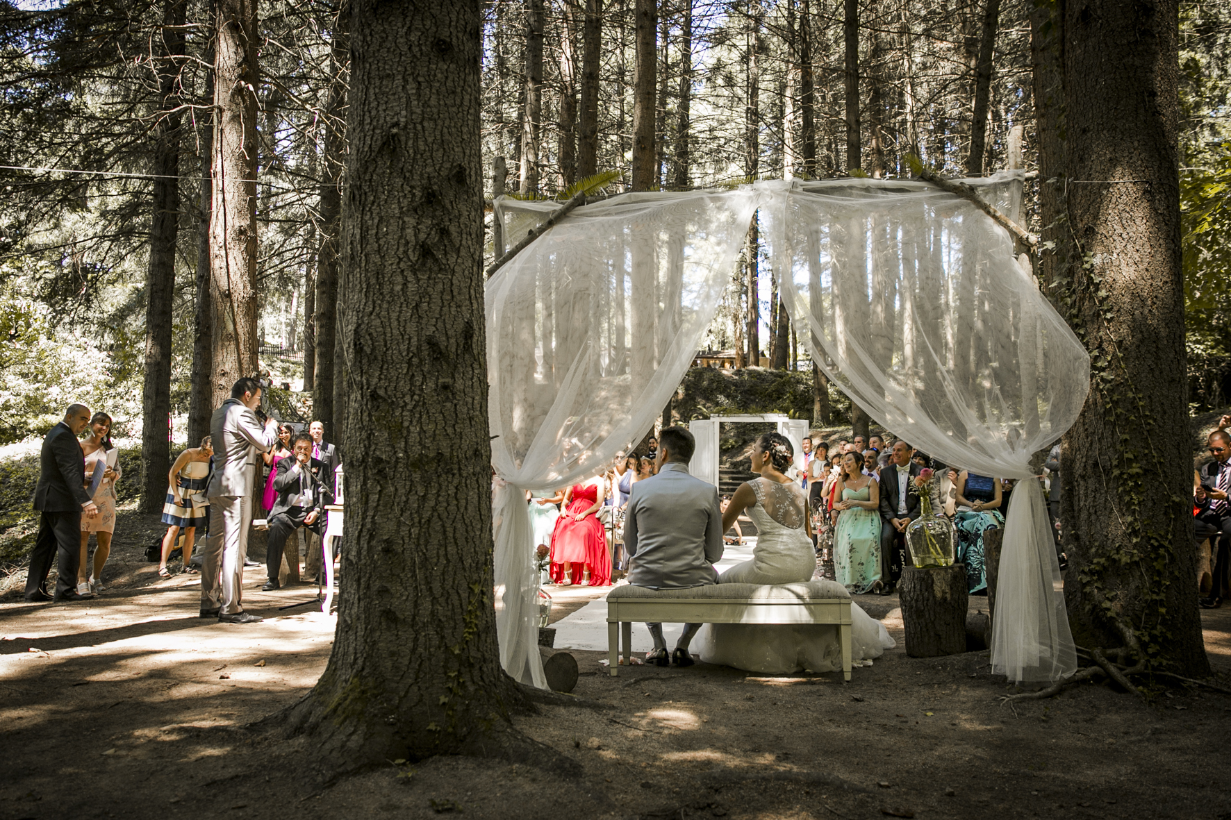 romantic picture of the outdoor ceremony in the forest mas del silenci wedding