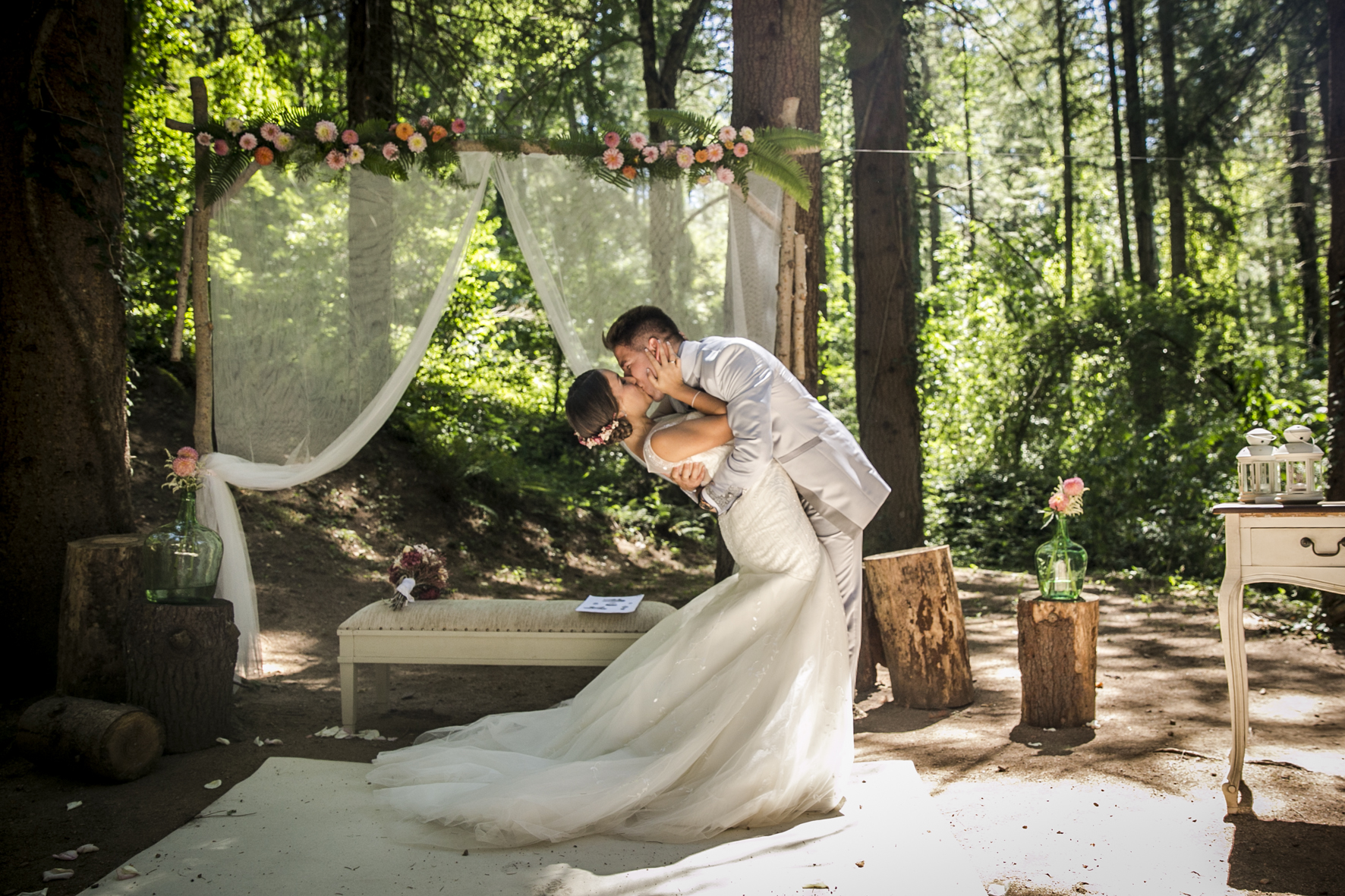romantic portrait of bride and groom at their outdoor wedding ceremony in the forest at mas del silenci wedding
