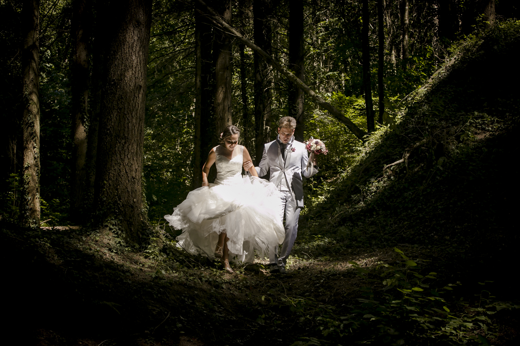 romantic portrait of bride and groom at their mas del silenci wedding while they walk through the light